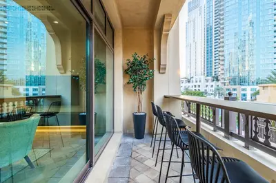 a balcony with chairs and a potted plant at Upgraded 1BR Retreat with Iconic Burj Khalifa Views in Dubai