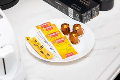 a plate with a box of chocolates on a table at Upgraded 1BR Retreat with Iconic Burj Khalifa Views in Dubai