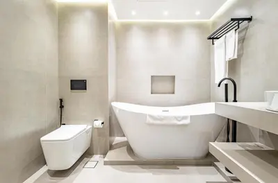 a bathroom with a tub and a toilet and a sink at Upgraded 1BR Retreat with Iconic Burj Khalifa Views in Dubai