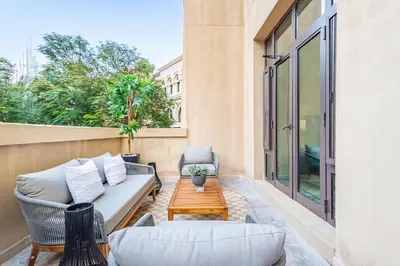 a patio with a couch and a coffee table at Upgraded 1BR Retreat with Iconic Burj Khalifa Views in Dubai