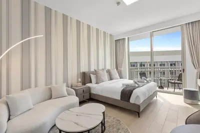 a hotel room with a bed and a couch at Perfect Getaway modern Studio in Luma 22 - JVC in Dubai