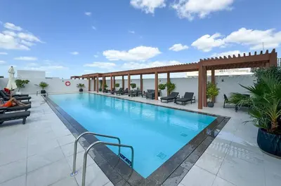 a large swimming pool on top of a building at Perfect Getaway modern Studio in Luma 22 - JVC in Dubai
