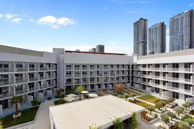 an aerial view of a building with tall buildings at Perfect Getaway modern Studio in Luma 22 - JVC in Dubai