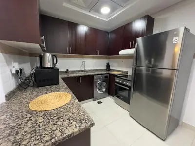 a kitchen with a stainless steel refrigerator and a dishwasher at Luxury apartment in Business bay 5 people in Dubai
