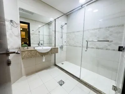 a bathroom with a glass shower and a sink at Luxury apartment in Business bay 5 people in Dubai
