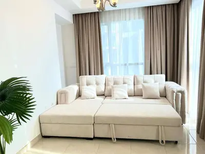 a white couch in a living room with a window at Luxury apartment in Business bay 5 people in Dubai