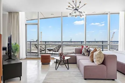 a living room with a couch and a large window at Silkhaus Sky Gardens Chic Studio in DIFC Living in Dubai