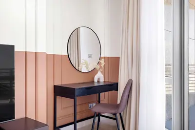 a dressing table with a mirror and a chair at Silkhaus Sky Gardens Chic Studio in DIFC Living in Dubai