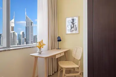 a room with a table and two chairs and a window at Silkhaus Comfort Studio at Sky gardens-DIFC in Dubai