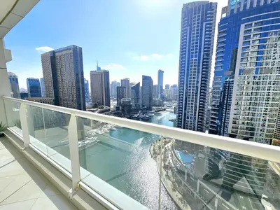 a balcony with a view of a city at SUNRISE HOMES - 2 BR with Panoramic Marina Views in Dubai