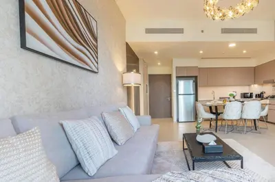 a living room with a couch and a table at Lux 2 King Bed Suite - Grande Signature Residences in Dubai