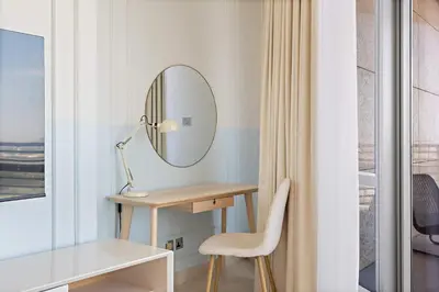 a dressing table with a mirror and a chair at Silkhaus Gallery Studio at Sky Gardens in Heart of DIFC in Dubai