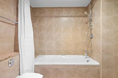 a bathroom with a bath tub and a toilet at Silkhaus Gallery Studio at Sky Gardens in Heart of DIFC in Dubai