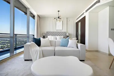 a living room with a white couch and a large window at Silkhaus Gallery Studio at Sky Gardens in Heart of DIFC in Dubai