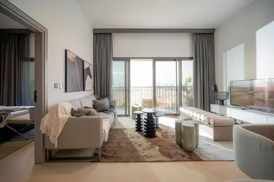 a living room with a couch and a tv at Spacious Unit With Burj Khalifa View in Dubai