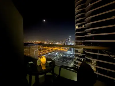 a room with a view of a city at night at 1BHK in Damac Masion mall street in Dubai