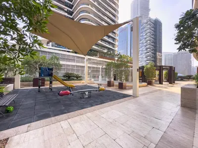 a playground with a table and a slide at 1BHK in Damac Masion mall street in Dubai