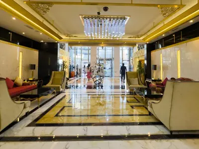 a lobby with chairs and a chandelier in a building at 1BHK in Damac Masion mall street in Dubai