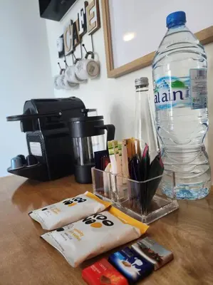 a counter top with a bottle of water and markers at Next to METRO 1BED with Panoramic Lake View in Dubai