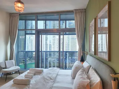 a bedroom with a large bed with a large window at Next to METRO 1BED with Panoramic Lake View in Dubai
