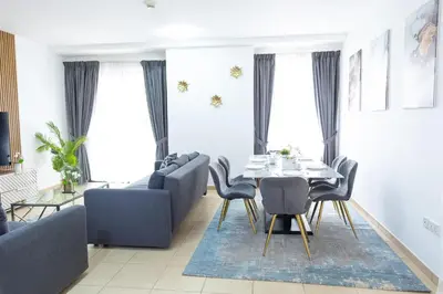 a living room with a couch and a table and chairs at HAPPY SEASON JBR apartments in Dubai