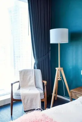a bedroom with a chair and a lamp and a window at Dream Inn - Damac Heights Fendi in Dubai