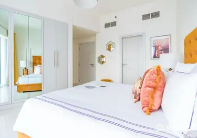 a bedroom with a white bed with a fish on it at Dream Inn - Damac Heights Fendi in Dubai