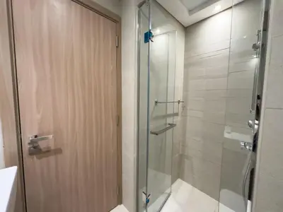 a shower with a glass door in a bathroom at Furnished Studio Azizi Riviera 3 in Dubai