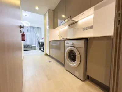 a kitchen with a washing machine in a kitchen at Furnished Studio Azizi Riviera 3 in Dubai