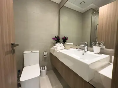 a bathroom with a sink and a toilet and a mirror at Studio in Azizi Riviera Dubai in Dubai