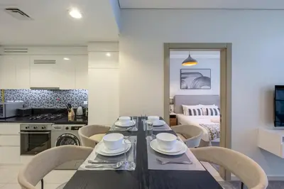 a kitchen and dining room with a table and chairs at Aykon City - Sophisticated Two Bed in Business Bay in Dubai