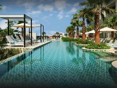 a pool at a resort with chairs and palm trees at 50th Floor 2 Bed with Burj and Sea view in Dubai