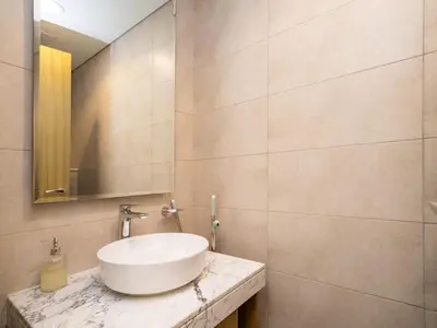 a bathroom with a sink and a mirror at 50th Floor 2 Bed with Burj and Sea view in Dubai