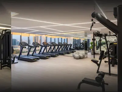 a gym with a row of treadmills and machines at 50th Floor 2 Bed with Burj and Sea view in Dubai