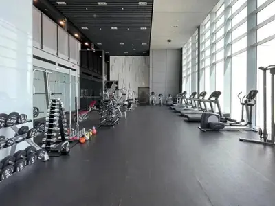 a gym with rows of treadmills and machines at Luxury 1-Bed DIFC Stay - City Views in a Prime Area in Dubai