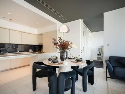 a kitchen and dining room with a table and chairs at Luxury 1-Bed DIFC Stay - City Views in a Prime Area in Dubai