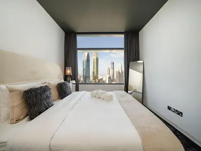 a bedroom with a large bed with a view of the city at Luxury 1-Bed DIFC Stay - City Views in a Prime Area in Dubai