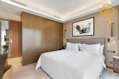 a bedroom with a large white bed in a room at Keysplease 2 BR Address Opera walking to Dubai Mall 55 in Dubai