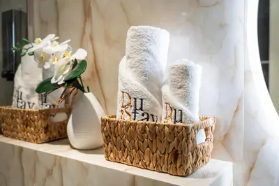 two baskets with towels and vases on a table at Downtown Luxury Treat - Premium Location! 2 bedroom! in Dubai