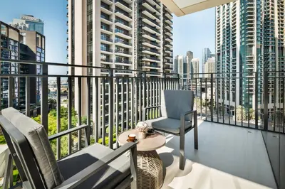 a balcony with chairs and a view of a city at Downtown Luxury Treat - Premium Location! 2 bedroom! in Dubai