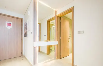 a hallway with a mirror and a sink in a house at Vacay Lettings Charming Retreat Azizi Riviera in Dubai
