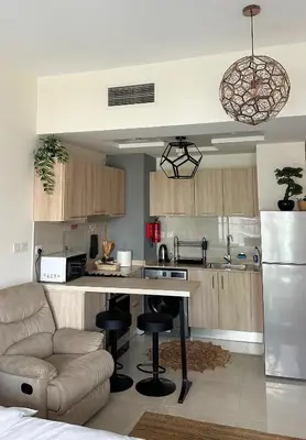a kitchen with a couch and a table in a room at Stylish studio, center area, close to Burj Khalifa in Dubai