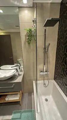 a bathroom with a tub and a sink and a shower at Stylish studio, center area, close to Burj Khalifa in Dubai