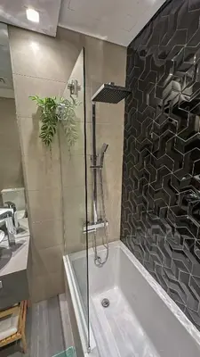 a bathroom with a shower and a bath tub at Stylish studio, center area, close to Burj Khalifa in Dubai