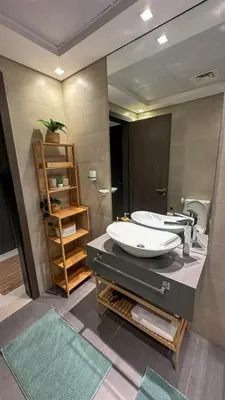 a bathroom with two sinks and a large mirror at Stylish studio, center area, close to Burj Khalifa in Dubai