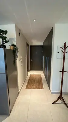 a hallway with a door and a rug on the floor at Stylish studio, center area, close to Burj Khalifa in Dubai