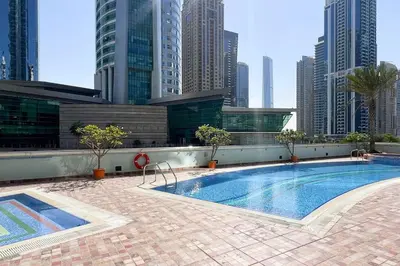 a swimming pool on the roof of a building with tall buildings at 2BR on 30th Floor in JLT Near Metro & Walking Distance to JBR Beach, Dubai Marina in Dubai