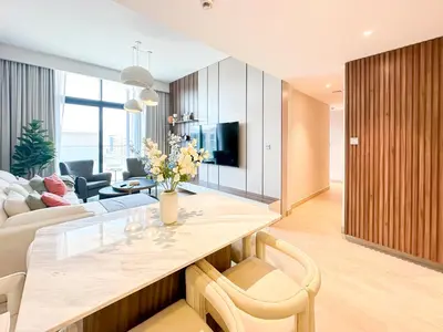 a kitchen and living room with a table and a couch at Luxury 3BR near to Downtown - Burj Khalifa & Pool Views - 10 min to Dubai Mall in Dubai