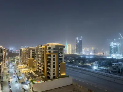 a view of a city at night with buildings at Luxury 3BR near to Downtown - Burj Khalifa & Pool Views - 10 min to Dubai Mall in Dubai