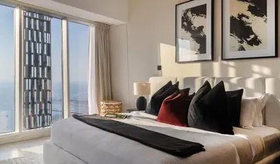 a bedroom with a large bed with a large window at Luxury 2BR in Cayan Tower with Sea, Marina & Dubai Eye View in Dubai